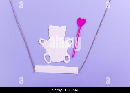 Lonely forgotten abandoned teddy bear on swing Stock Photo