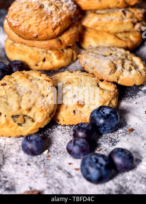 Bakers gonna bake. Serving food on slate. Oatmeal cookies biscuit with blueberry on dark tiles countrylike. Chocolate chip cookies shop on window disp Stock Photo