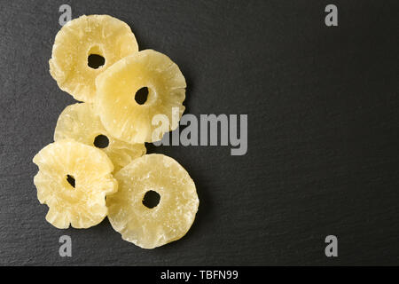 Tasty dried pineapple on dark background Stock Photo
