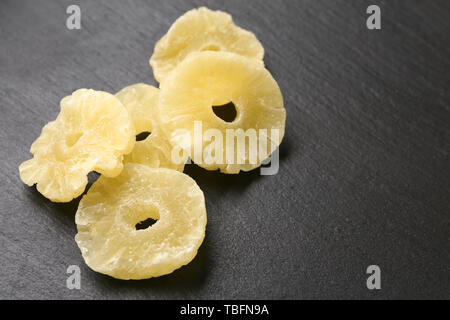 Tasty dried pineapple on dark background Stock Photo