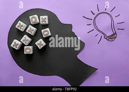 Human head with cubes and lightbulb on color background Stock Photo