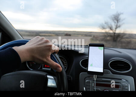 Car driver using mobile phone for navigation Stock Photo