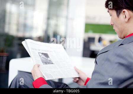 A white-collar worker is busy at work in the office. Stock Photo