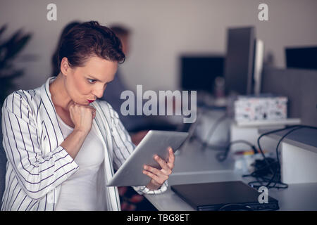 Stylish brunette working from home in her home office Stock Photo