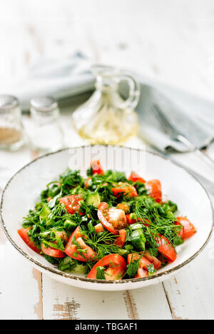 Healthy tomato salad with cucmbers, dill, onion and parsley Stock Photo