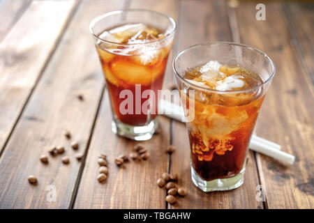 Tasty appetizing refreshing cold coffee with ice in glasses. Stock Photo