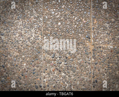 rough texture surface of exposed aggregate finish, Ground stone washed floor, made of small sand stone in light brown color Stock Photo