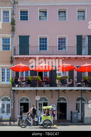 New Orleans, LA, USA -- May 23, 2019.  People enjoy having breakfast on a balcony in the French Quarter. Stock Photo