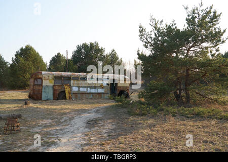 Old school bus as hideout Stock Photo