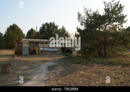 Old school bus as hideout Stock Photo