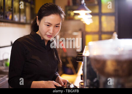 waitress serving in modern cafe Stock Photo