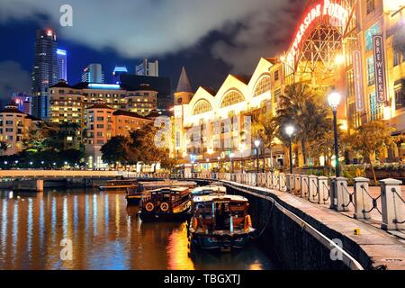 SINGAPORE - APR 5: Clarke Quay at night with street view and restaurant on April 5, 2013 in Singapore. As a historical riverside quay, it is now the hub of Singaporean nightclubs. Stock Photo