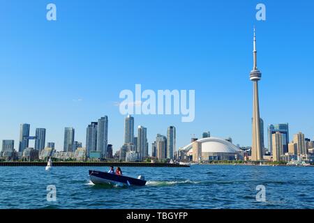 TORONTO, CANADA - JULY 3: Toronto skyline with boat on July 3, 2012 in Toronto, Canada. Toronto with the population of 6M is the provincial capital of Ontario and the largest city in Canada. Stock Photo