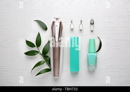 Tools for professional pedicure with nail polish on white wooden background Stock Photo