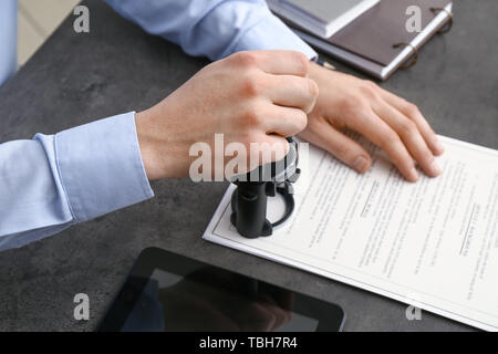 Notary public stamping document in office Stock Photo