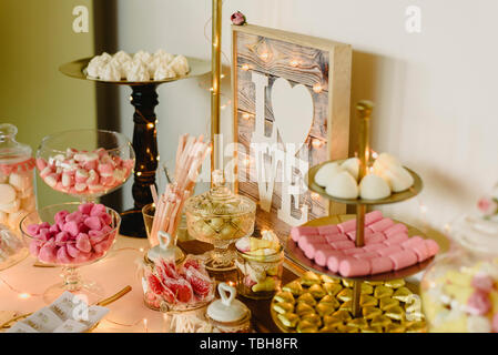 Candy bar beautifully decorated with sweets in a vintage event. Stock Photo