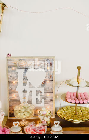 Candy bar beautifully decorated with sweets in a vintage event. Stock Photo