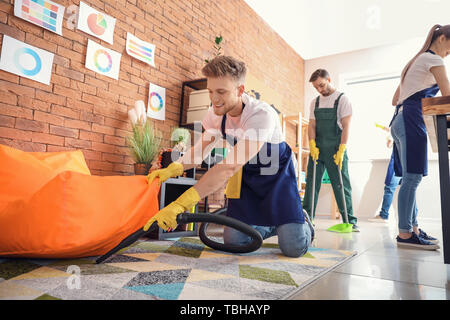 Male janitor cleaning office Stock Photo