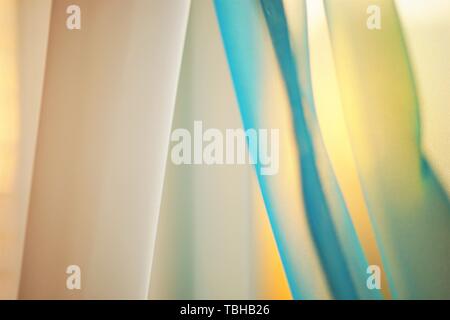 Sunny sunset light through the thin curtains on the window Stock Photo