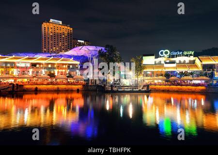 SINGAPORE - APR 5: Clarke Quay at night with street view and restaurant on April 5, 2013 in Singapore. As a historical riverside quay, it is now the hub of Singaporean nightclubs. Stock Photo