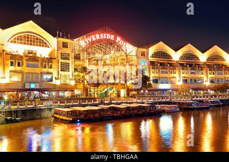 SINGAPORE - APR 5: Clarke Quay at night with street view and restaurant on April 5, 2013 in Singapore. As a historical riverside quay, it is now the hub of Singaporean nightclubs. Stock Photo