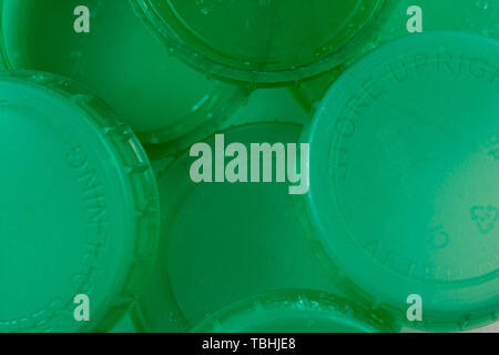 Close up of green milk bottle tops showing the concept of recycling or drinking semi skimmed milk Stock Photo