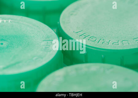 Close up of green milk bottle tops showing the concept of recycling or drinking semi skimmed milk Stock Photo