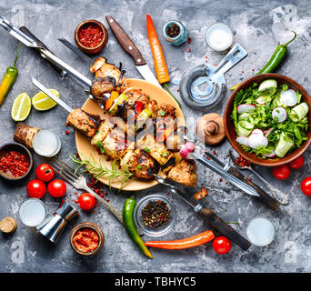 Barbecue skewers.Shish kebab and healthy vegetable salad.Summer food Stock Photo