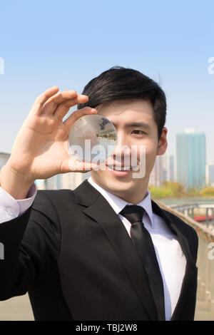 Business white collar holding crystal ball Stock Photo - Alamy