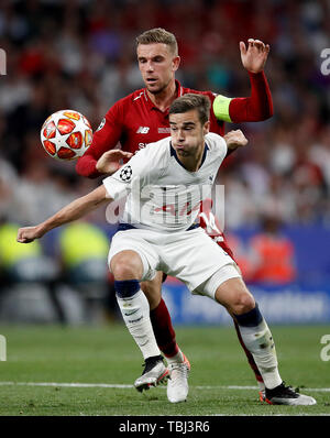 Harry Winks of Tottenham and Jordan Henderson of Liverpool compete for