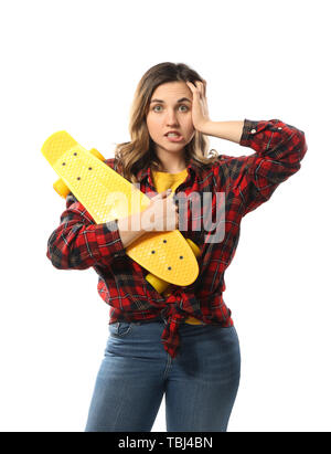 Portrait of emotional young woman with skateboard on white background Stock Photo