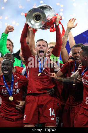 Liverpool's Jordan Henderson lifts the trophy after the final whistle during the UEFA Champions League Final at the Wanda Metropolitano, Madrid. Stock Photo