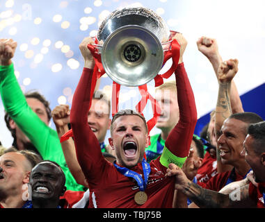 Liverpool's Jordan Henderson lifts the trophy after the final whistle during the UEFA Champions League Final at the Wanda Metropolitano, Madrid. Stock Photo