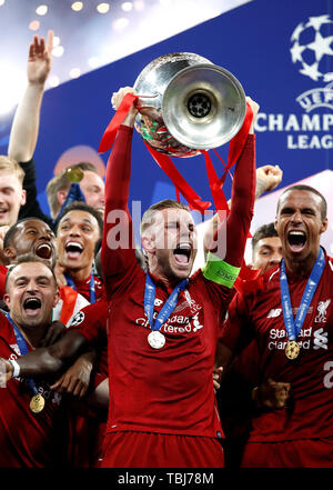 Liverpool's Jordan Henderson celebrates with the trophy after the UEFA Champions League Final at the Wanda Metropolitano, Madrid. Stock Photo