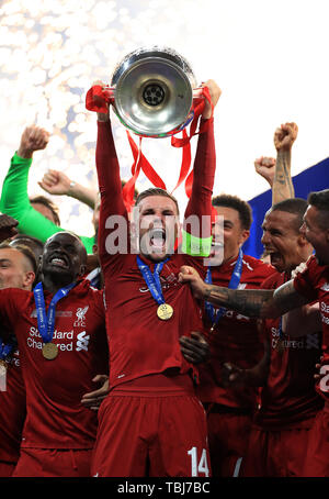 Liverpool's Jordan Henderson lifts the trophy after the final whistle during the UEFA Champions League Final at the Wanda Metropolitano, Madrid. Stock Photo