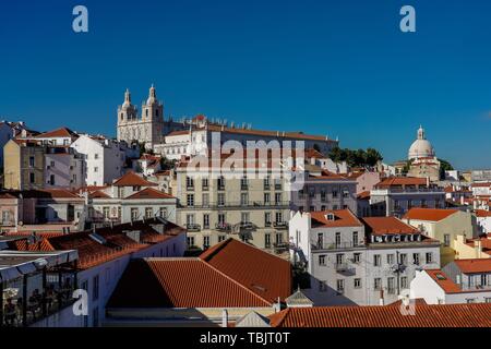 Lisbon, Portugal. 14th May, 2019. 14.05.2019, Lisbon, capital of Portugal on the Iberian Peninsula in the spring of 2019. View from the Largo Portas do Sol over the red tiled roofs of the city. In the background the church or the monastery of São Vicente de Fora, a Manueline, originally Romanesque complex of sacred buildings in Lisbon and the Igreja de Santa Engrácia, to the Church of the Holy Engrácia, is a large Baroque church of the 17th century in the Freguesia São Vicente. Credit: dpa/Alamy Live News Stock Photo