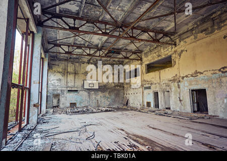 Abandoned school in Pripyat, Chernobyl zone. Abandoned gym. Abandoned basketball hall. Stock Photo