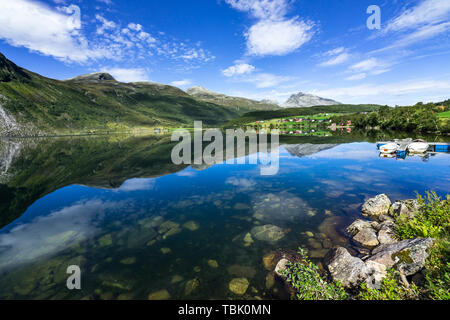The amazing landscape of Eidsvatnet lake reflected in the water. Eidsvatnet lake is located between Geirangerfjord and Eidsdal, Norway Stock Photo