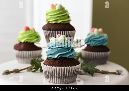Sweet Easter cupcakes on table Stock Photo