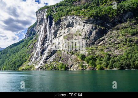 Seven Sisters Waterfall over Geirangerfjord, Norway. It consists of seven separate streams, and the tallest of the seven has a free fall of 250 m Stock Photo