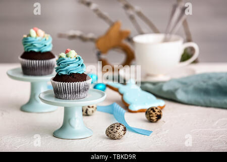Tasty Easter cupcakes on table Stock Photo