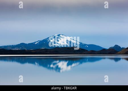 Reflection of the snow-covered volcanic cone Hekla in Hrauneyjalon, South Iceland, Iceland Stock Photo