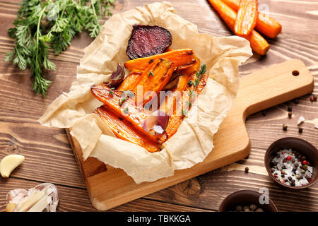 Tasty cooked vegetables with spices on wooden table Stock Photo