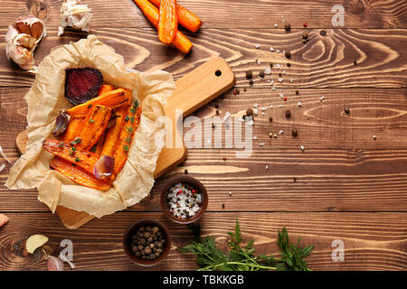 Tasty cooked vegetables with spices on wooden table Stock Photo