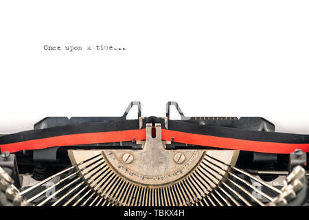 close view of vintage typewriter type bars ready to type a new story on a sheet  beginning with once upon a time Stock Photo