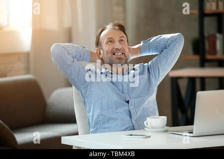 Handsome mature man having break at home Stock Photo