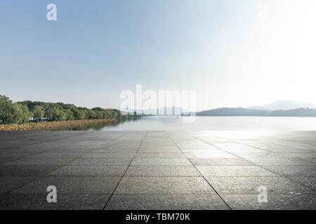 empty marble floor with beautiful lake in blue sky Stock Photo