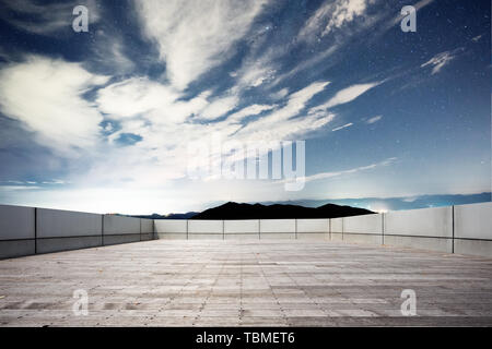 Empty brick floor with green hill Stock Photo