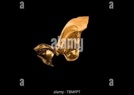 golden soft satin flying in wind on background Stock Photo