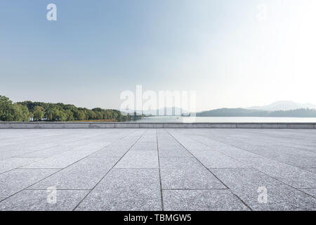 empty marble floor with beautiful lake in blue sky Stock Photo